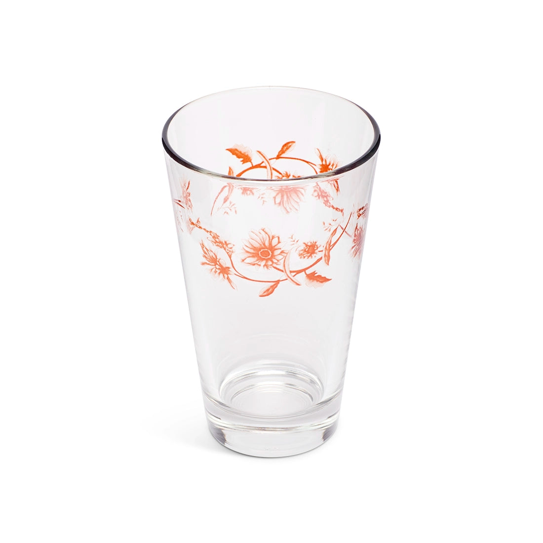 Orange floral juice glass from above showing the flowers through the glass