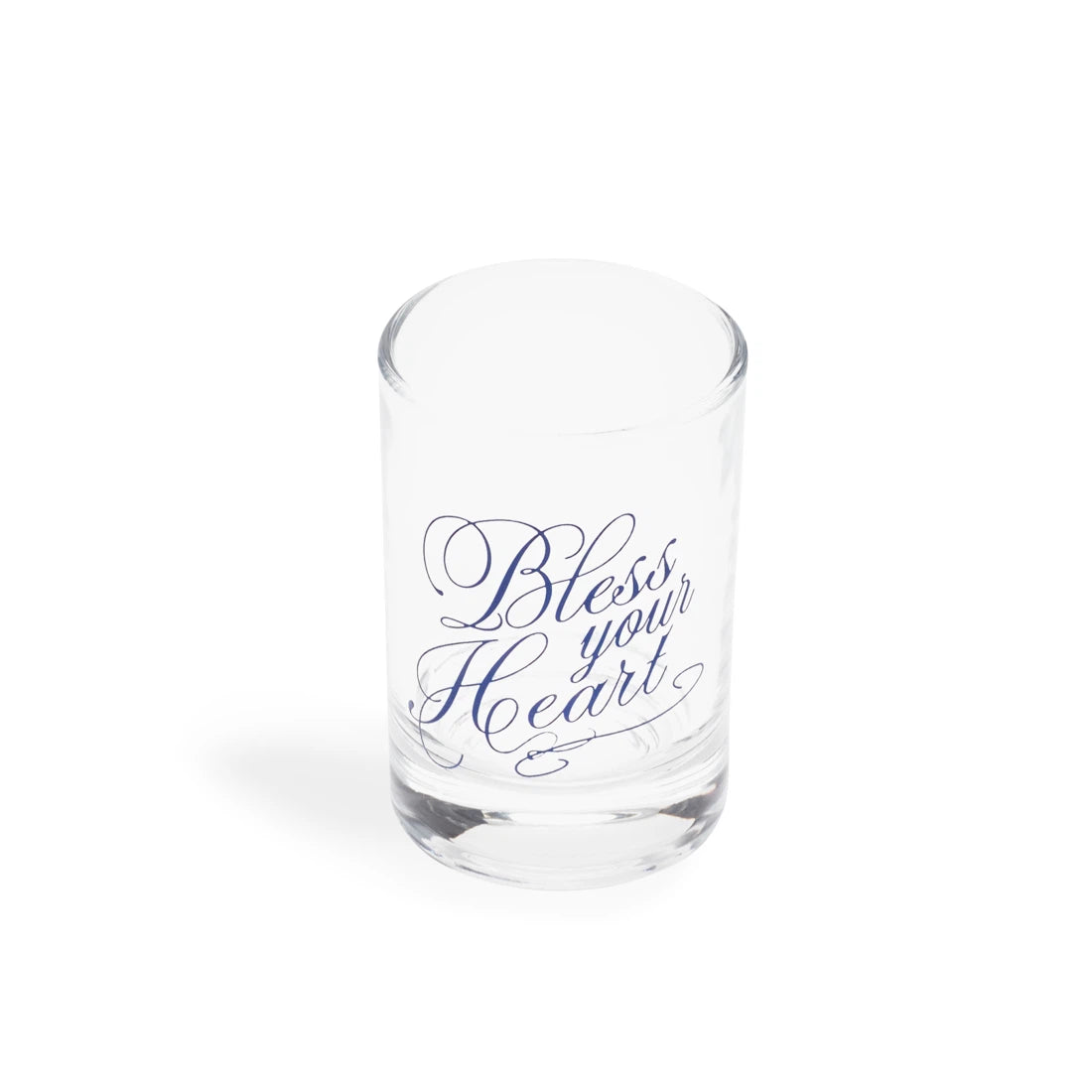 Clear shot glass with navy script reading Bless your Heart, at a slight angle