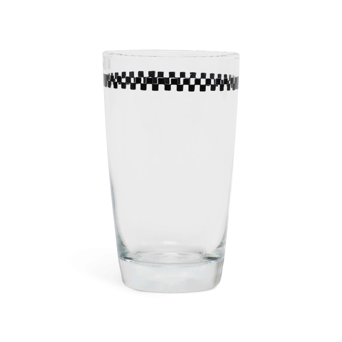 Clear juice glass with a black and white checkerboard band below the rim, side view