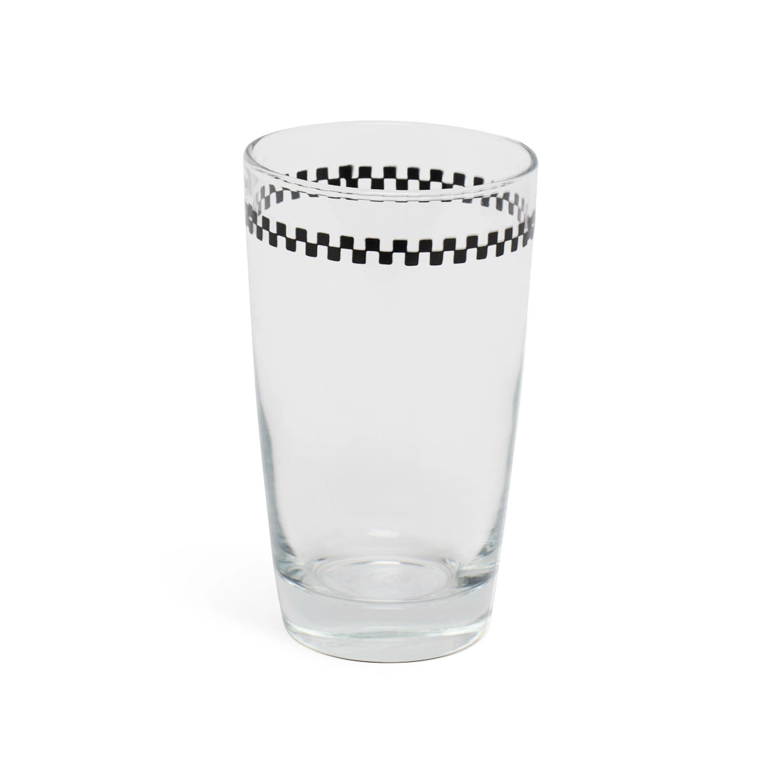 Checkerboard juice glass at a slight angle showing the rim