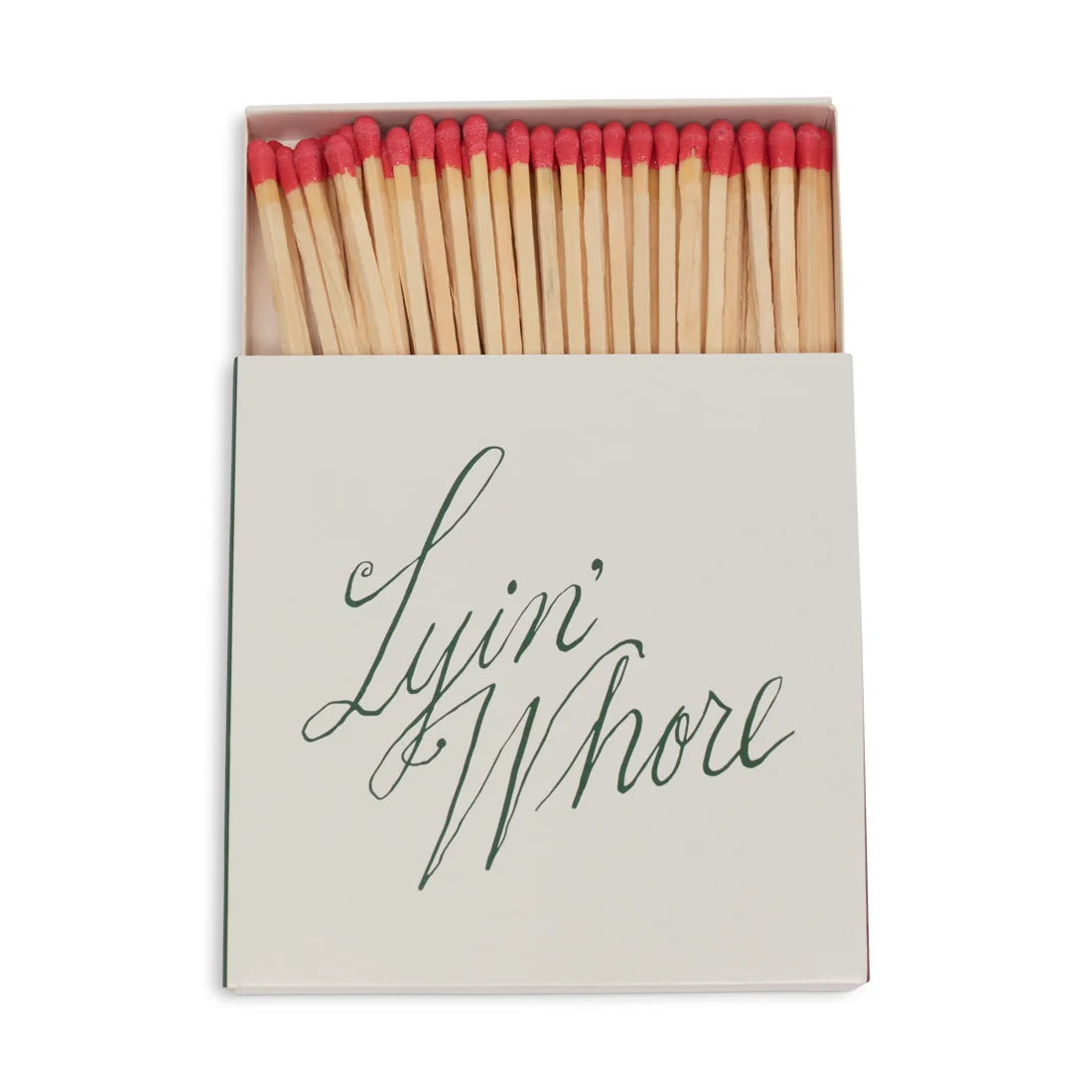 Square box of long red-tipped matches, open, white cover with Lyin' Whore in green cursive