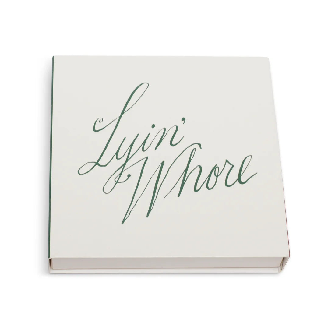 White square matchbox at an angle with Lyin' Whore in green cursive script