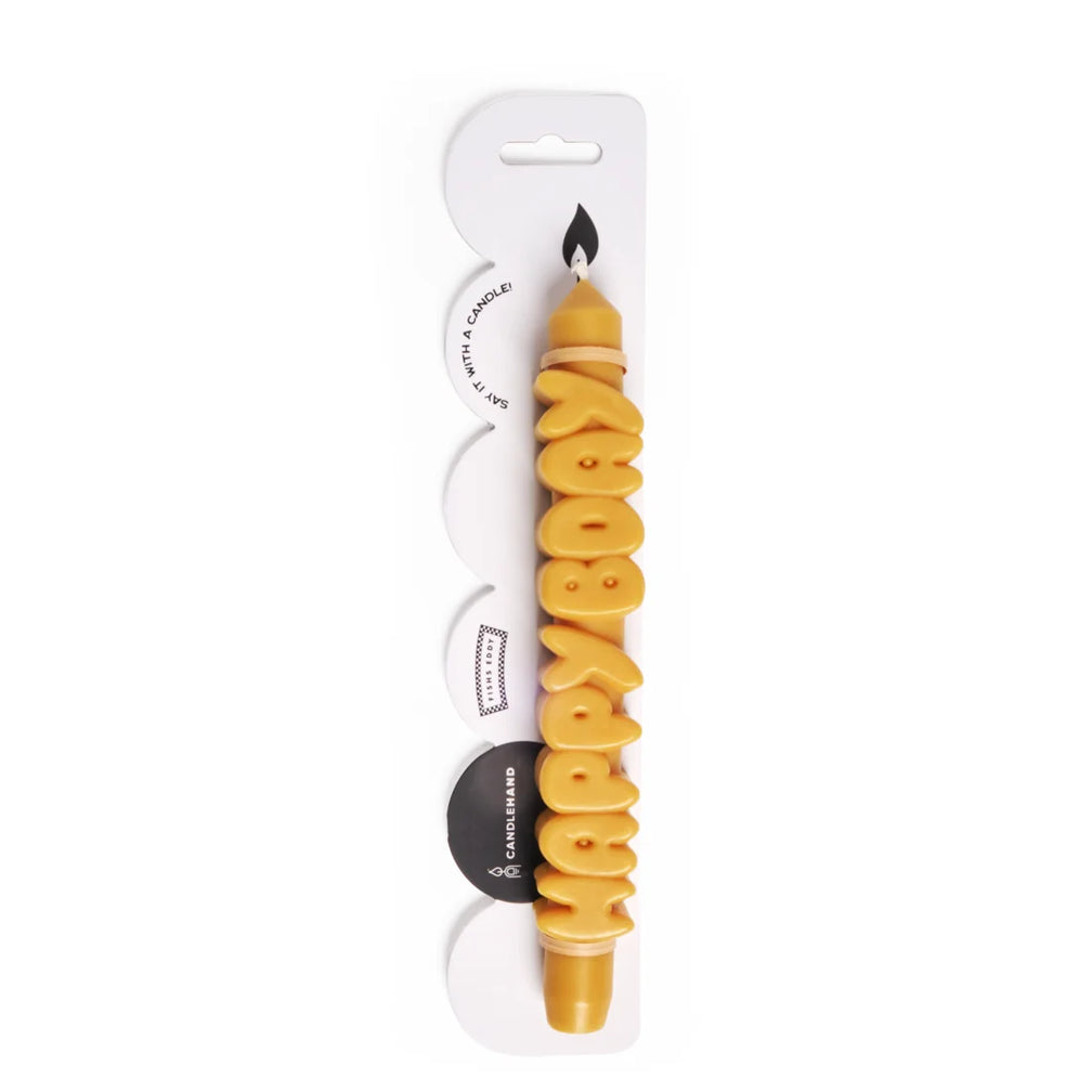 Yellow Happy Bday taper candle in its clear Candlehand blister packaging