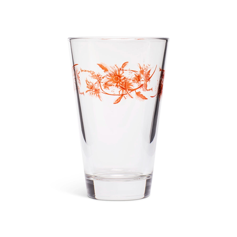Clear juice glass with an orange vintage floral garland around the upper half