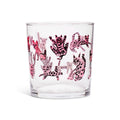 Clear lowball glass covered in playful pink and black striped cartoon cats