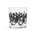 Clear lowball glass with a band of black bicycle silhouettes stacked together