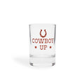 Clear shot glass with a red horseshoe, stars and COWBOY UP lettering, front view