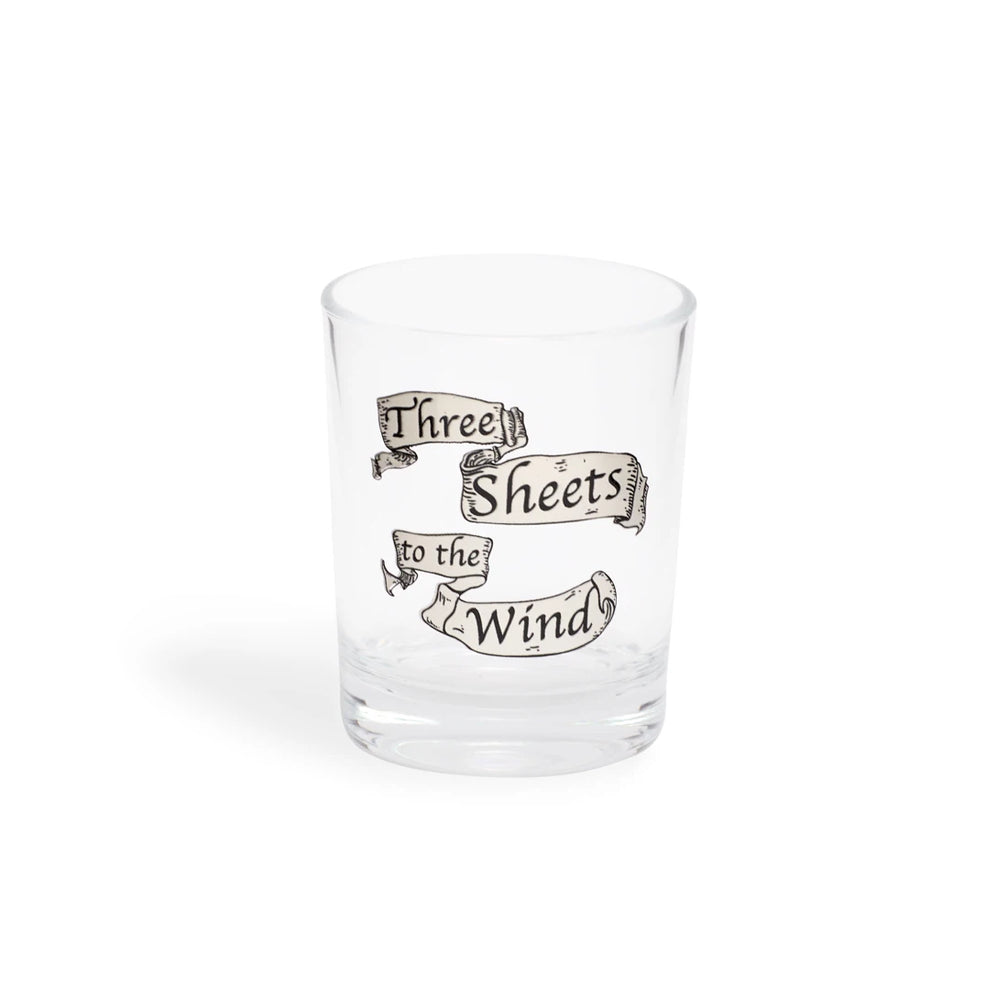 Clear shot glass with Three Sheets to the Wind lettered on tan scroll banners