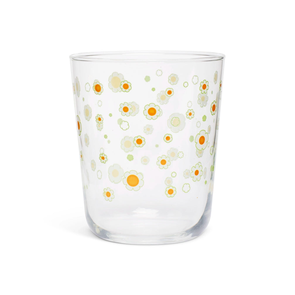 Clear juice glass with a scattered print of small white and yellow daisies
