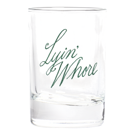 Pleasantries - Lyin' Whore Shot Glass compact glassware, with a crisp silhouette and decorative details that stand out on the table; a playful, space-saving piece for shots, tasting pours, or bar-cart display. Primary product view highlights the overall design and proportions.