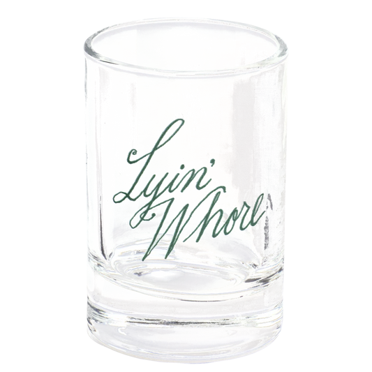 Pleasantries - Lyin' Whore Shot Glass compact glassware, with a crisp silhouette and decorative details that stand out on the table; a playful, space-saving piece for shots, tasting pours, or bar-cart display. Alternate product view shows more of the shape, finish, and design details.