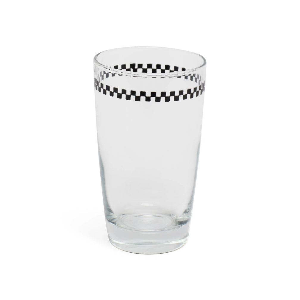 Checkerboard juice glass at a slight angle showing the rim