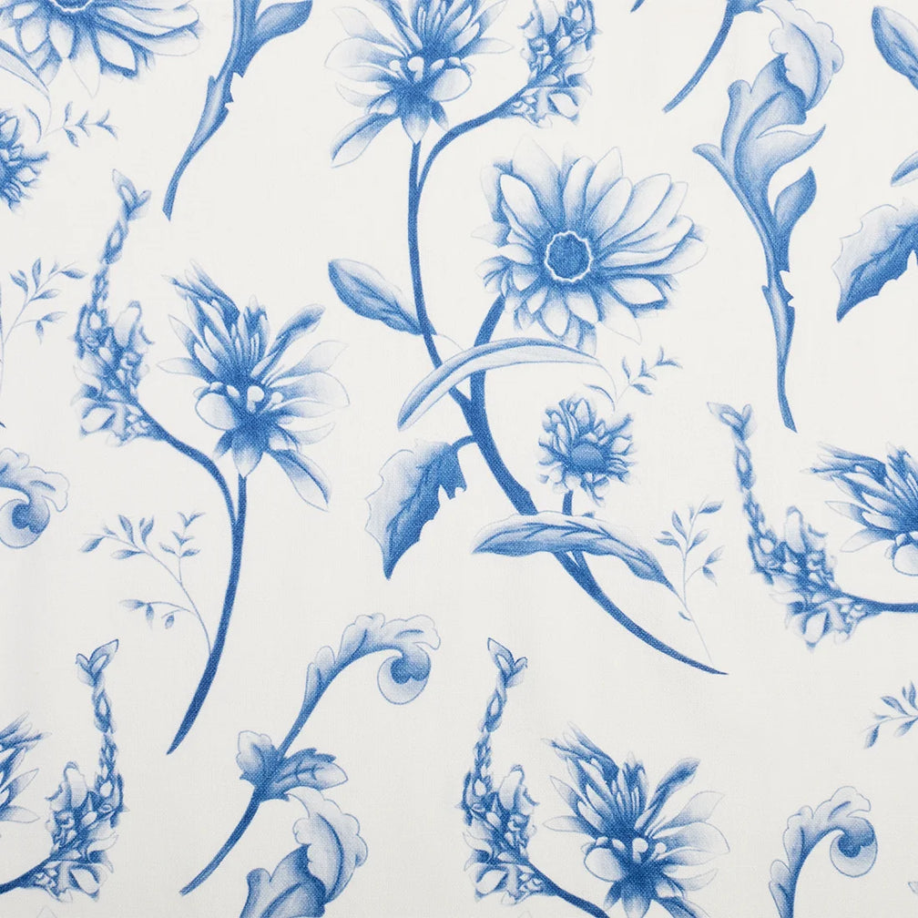 Close-up of tea towel fabric showing detailed blue vintage wildflowers on cream