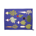 Royal blue tea towel laid flat with illustrated root vegetables like carrots, beets and radishes