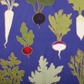 Close-up of Root Down tea towel fabric with radishes, beets and leafy greens on royal blue