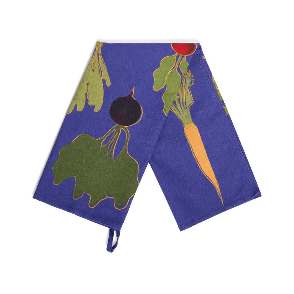Royal blue Root Down tea towel draped open showing the illustrated beets and carrots