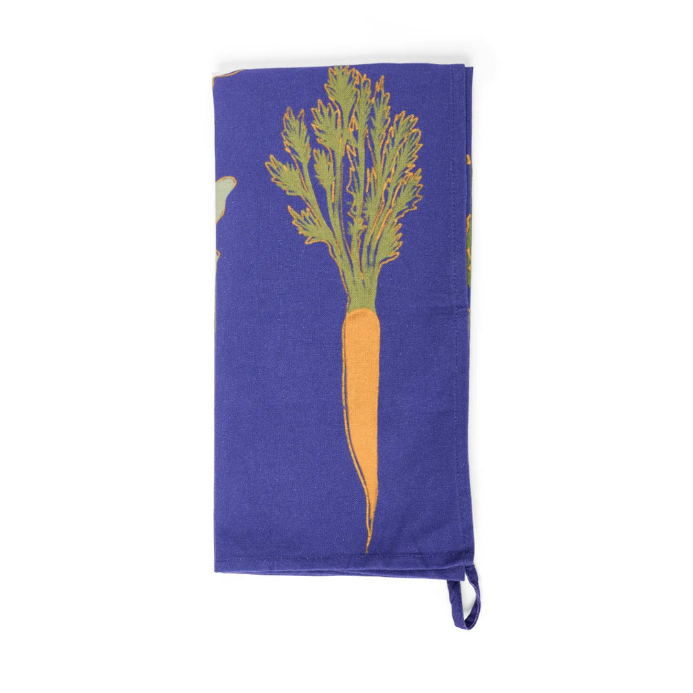 Folded royal blue tea towel with an illustrated orange carrot and green tops