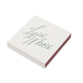 White square matchbox with Lyin' Whore green cursive script, angled to show the striker side