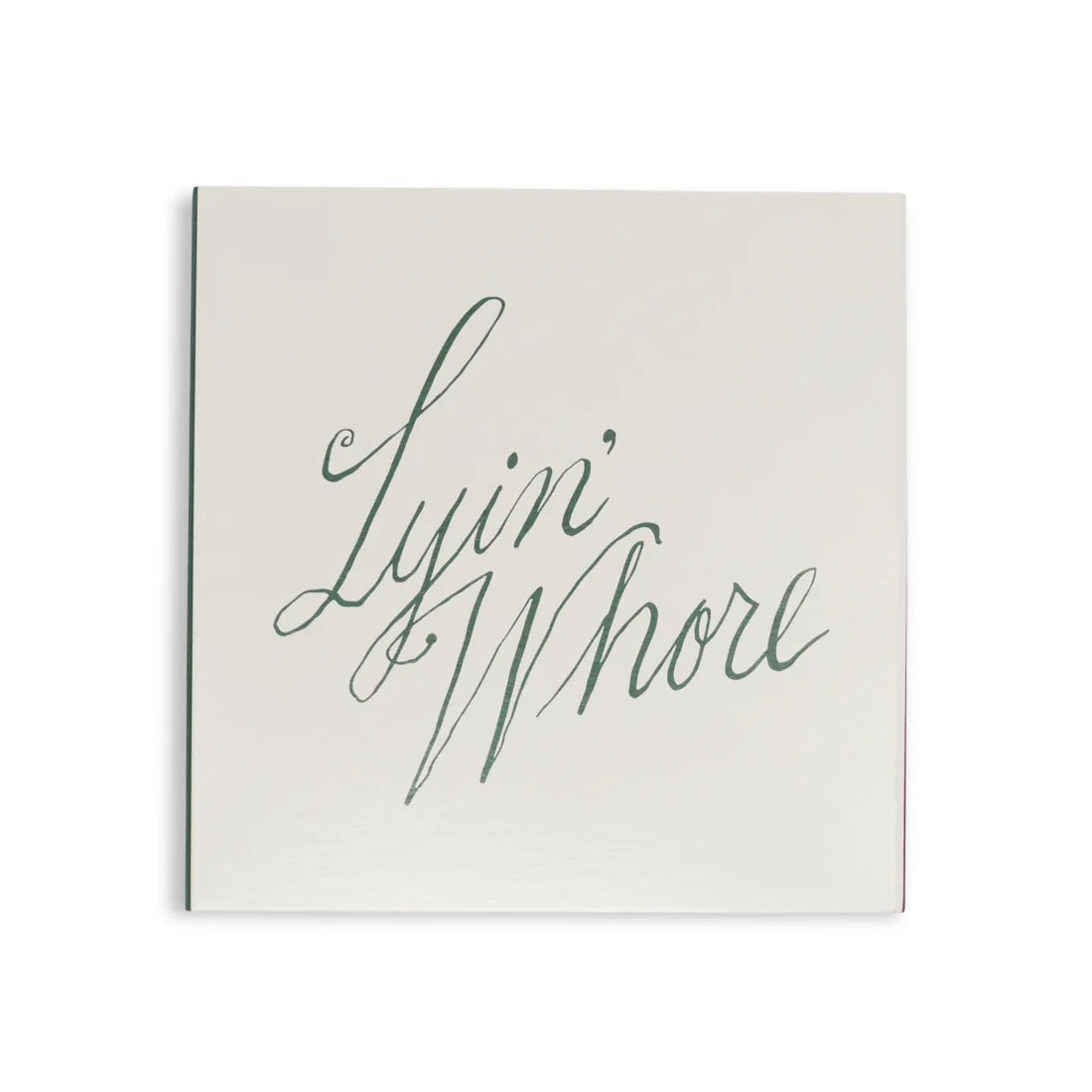 White square matchbox from above with Lyin' Whore in green cursive script