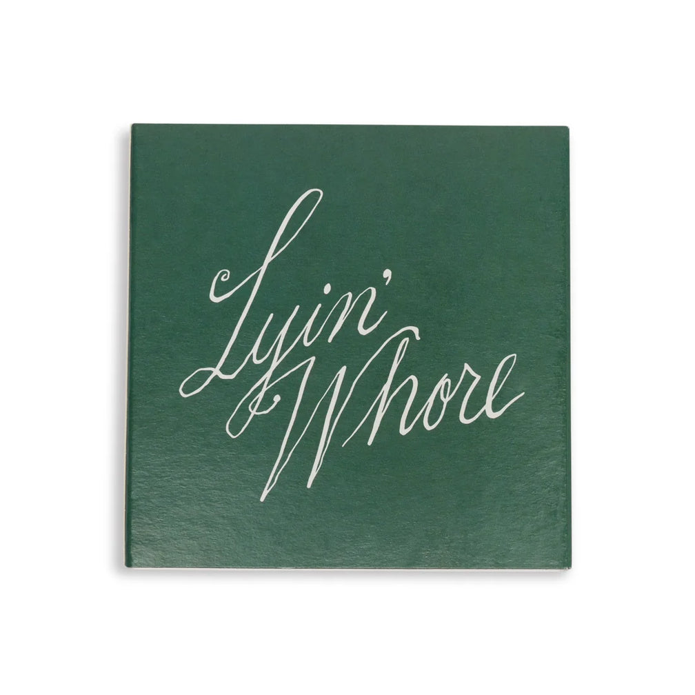 Green square matchbox cover, straight-on view of white cursive Lyin' Whore lettering