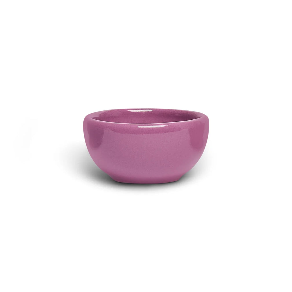 Small mauve orchid pink ceramic nut bowl with rounded sides, side view