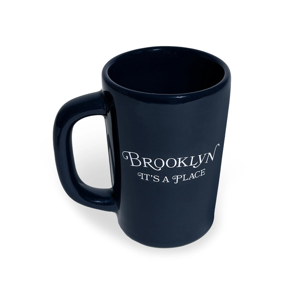 Navy Brooklyn It's A Place mug at a slight angle showing the rim
