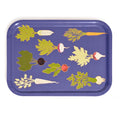 Royal blue rectangular tray from above with illustrated root vegetables like carrots, beets and radishes