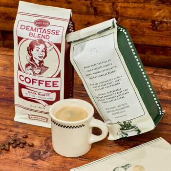 Coffee package, mug, and beans on a wooden surface