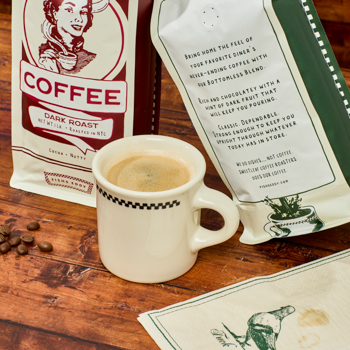 Coffee cup with coffee beans and a coffee bag on a wooden surface