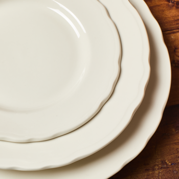 Stack of white ceramic plates on a wooden surface