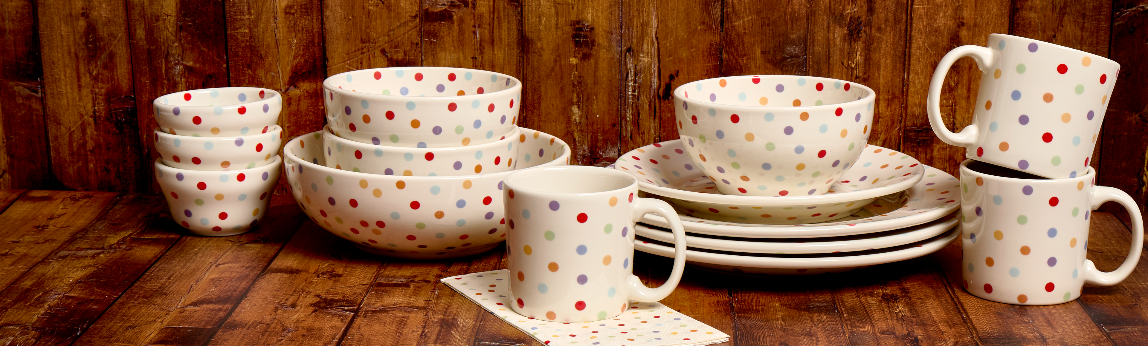 Polka dot ceramic tableware set on a wooden surface