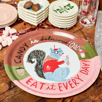 Decorative plate with cartoon characters and text on a wooden table