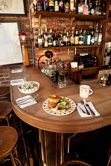 Bar counter with food and drinks in a cozy bar setting
