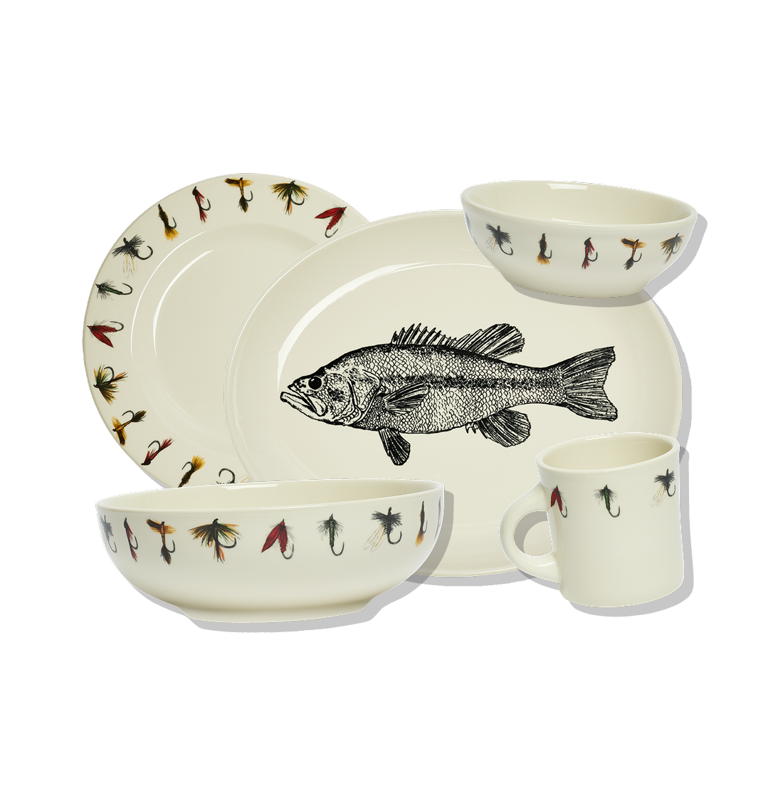 Ceramic tableware set with fish and fly fishing lure designs on a white background