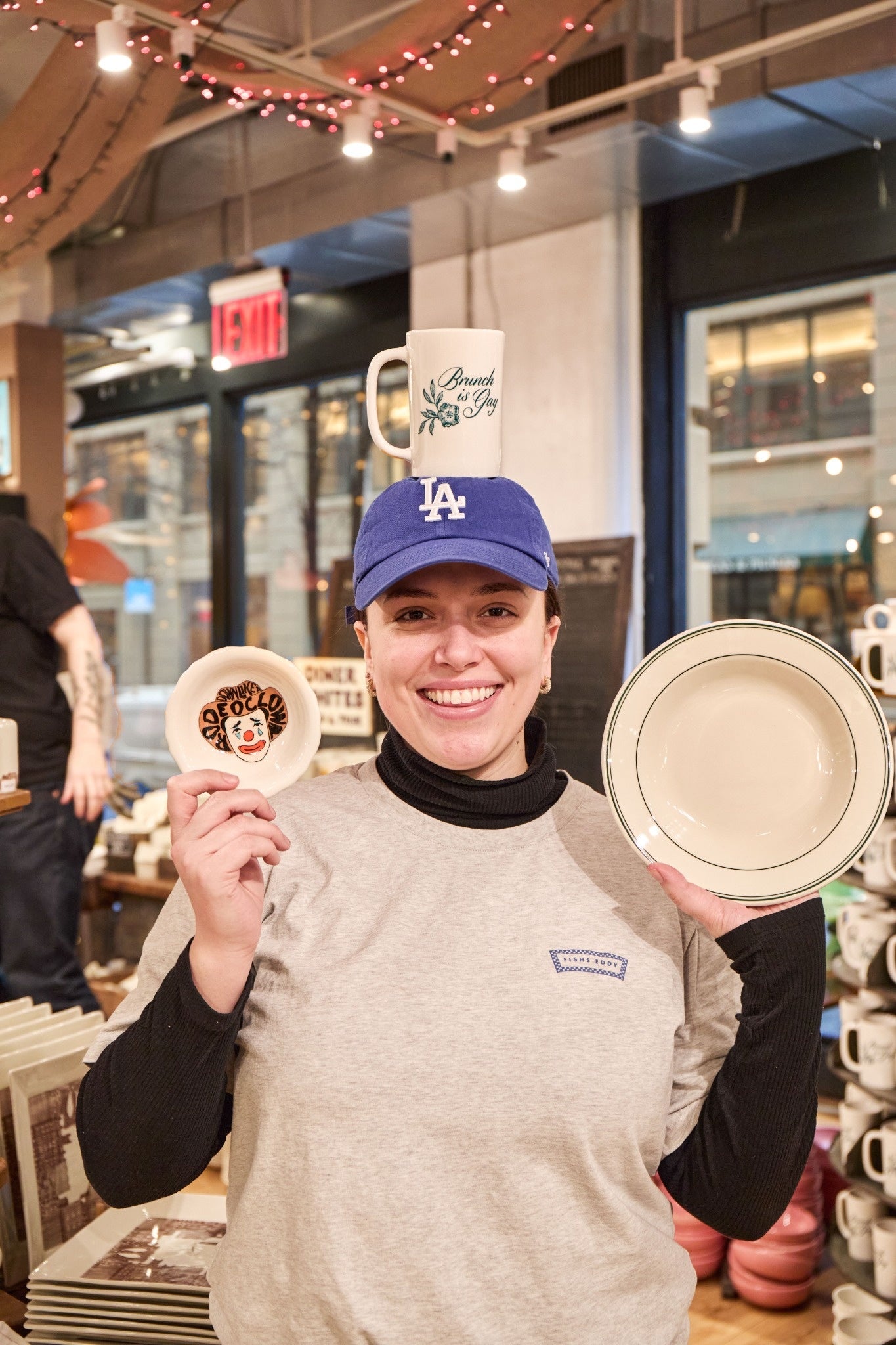 Person holding ceramic items in a store setting